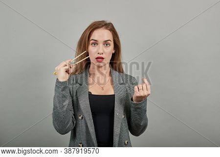 Hand Using Chopstick, Fingers Holding Chopsticks And Ready To Eat Isolated On Background. Clipping P
