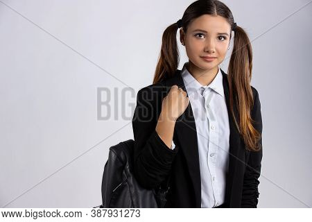 Caucasian Girl With School Bag And Long Hair Looking At The Camera