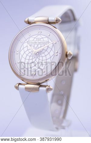 Geneve, Switzerland 01.10.2020 - Claude Bernard Swiss Made Watch Gold Pvd Coating Leather Strap Isol
