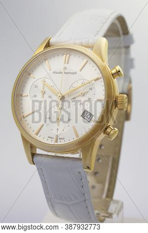 Geneve, Switzerland 01.10.2020 - Claude Bernard Man Swiss Made Watch Gold Pvd Coating White Dial Lea