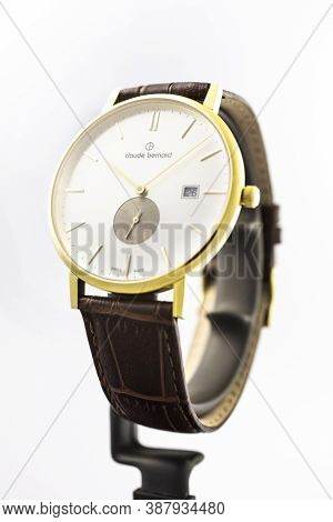 Geneve, Switzerland 01.10.2020 - Claude Bernard Man Swiss Made Watch Gold Pvd Coating White Dial Lea