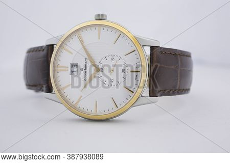 Geneve, Switzerland 01.10.2020 - Claude Bernard Man Swiss Made Watch Gold Pvd Coating White Dial Lea