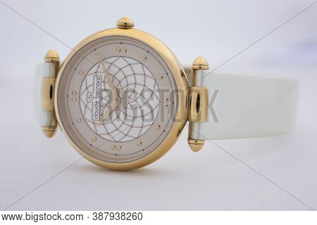 Geneve, Switzerland 01.10.2020 - Claude Bernard Swiss Made Watch Gold Pvd Coating Leather Strap Isol