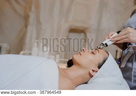 Lateral View Of Woman Facial Massage Spa Procedure. Electric Stimulation Facial Skin Care. Microcurr
