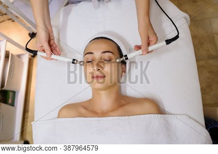 Lateral View Of Woman Facial Massage Spa Procedure. Electric Stimulation Facial Skin Care. Microcurr