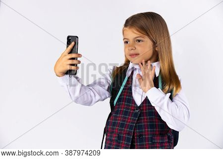 Portrait Of Beautiful Little Girl With Blonde Hair Smile, Gesturing Hi To Mobile. Studio Shot Isolat