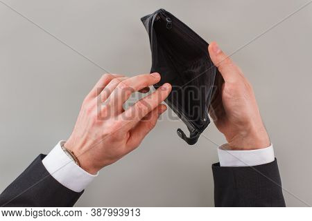 Mans Hands Open An Empty Wallet. No Salary, No Cash. Powerty Concept.
