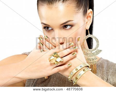 Woman With Golden Nails And Beautiful Gold Jewelry