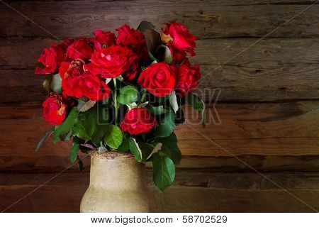 Beautiful Roses With Frech And Wilted Buds In Ceramic Jug On Rustic Wooden  Background