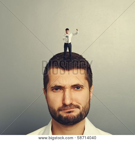 small boss standing on the head and screaming at bad worker