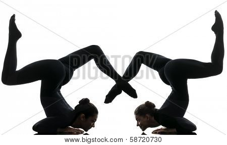 two women contortionist practicing gymnastic yoga in silhouette  on white background