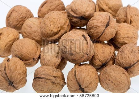 ripe walnuts heap isolated on white background