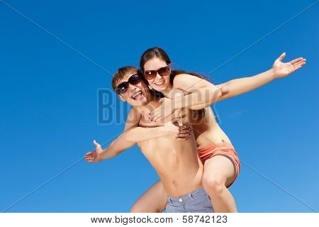 Portrait of a happy young couple enjoying at beach