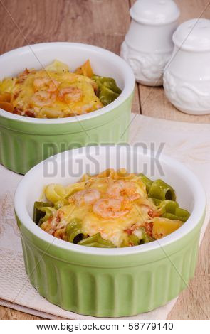 Heart shaped pasta with cheese and shrimp on a wooden table