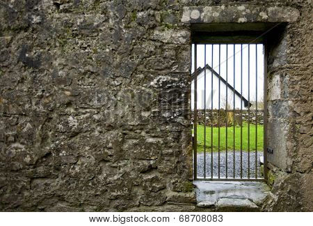 Locked gate in old stone wall