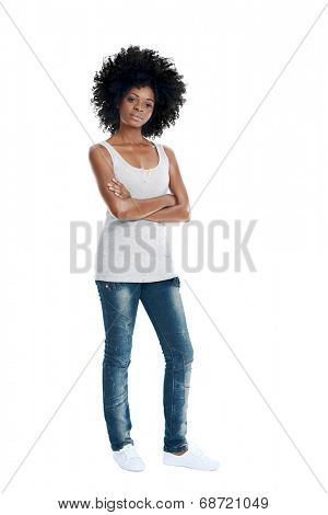 African woman with funky afro and casual clothing arms crossed in studio