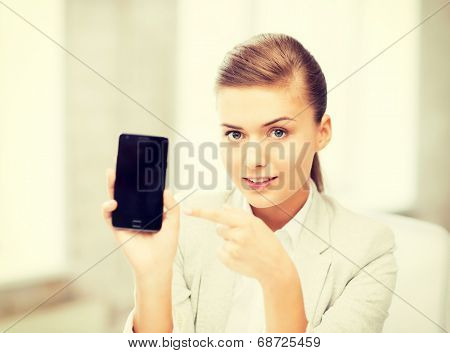 picture of smiling businesswoman with smartphone in office