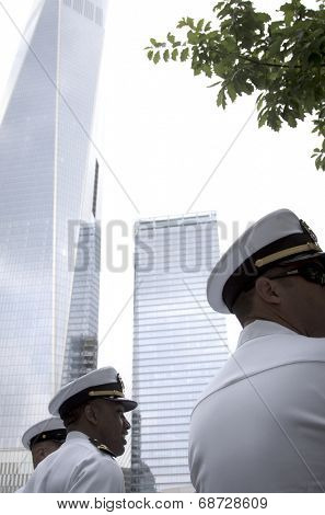 NEW YORK - MAY 23, 2014: Low angle view of US Navy officers with the Freedom Tower in the background during the re-enlistment and promotion ceremony at the National September 11 Memorial site.