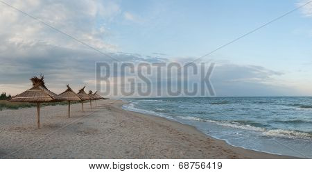Straw Umbrellas On Beach