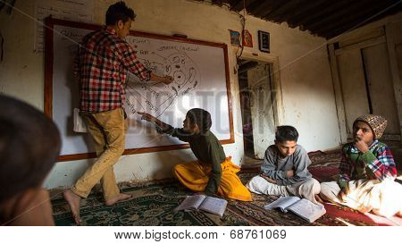 KATHMANDU, NEPAL - DEC 9, 2013: Unknown children in lesson at Jagadguru School. School established at 2013, to let new generation learn Sanskrit and preserve Hindu culture. 
