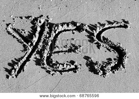 Written Yes Designed On The Sand Of The Beach In Black And White