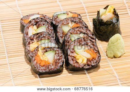 Suchi Roll With Vegetable And Coast Rice Inside Beside Wasabi