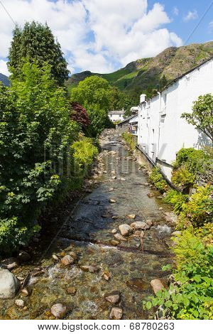 View of stream and mountains in Coniston town Lake District England with hot sunny summer weather