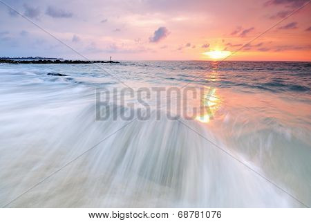 Long exposure of waves at sunset