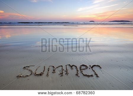 summer hand written in the sand on the beach
