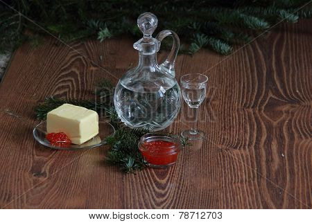 Still-life with red caviar and vodka and fur-tree branches