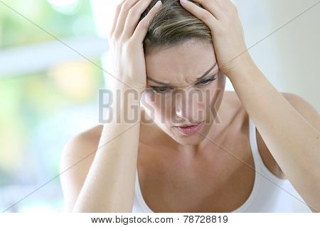 Portrait of woman suffering migraine
