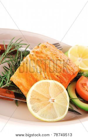 served fish: roast salmon fish over glass plate isolated over white background