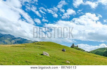 View on small church in mountains with beautiful clouds