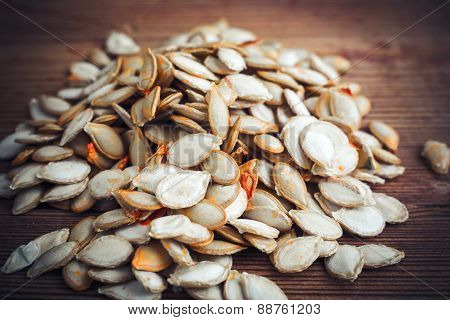 pumpkin seeds on wood background