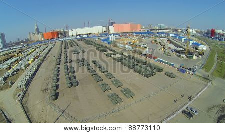 MOSCOW, RUSSIA - APRIL 20, 2014: Military vehicles at Khodynskoe Field prepared for the parade of victory and construction site of shopping center Aviapark, aerial view