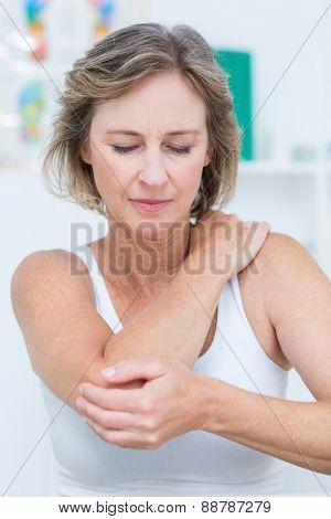 Woman having elbow pain in medical office