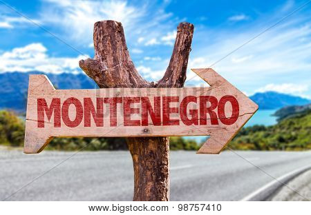 Montenegro wooden sign with road background