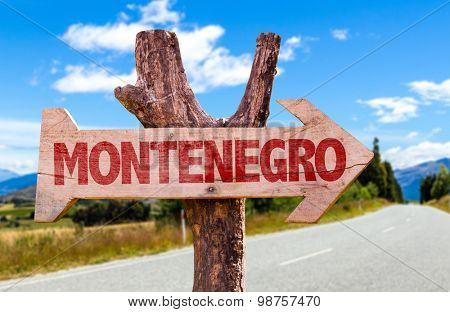 Montenegro wooden sign with road background