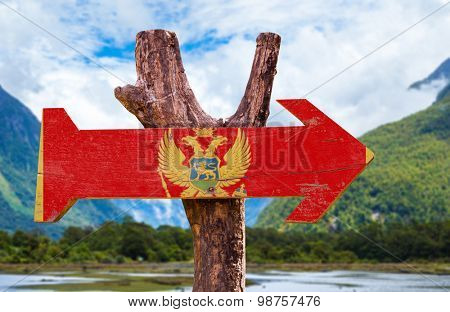 Montenegro Flag wooden sign with mountains background