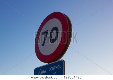 Isolated traffic sign. Seventy miles per hour speed limit sign round red