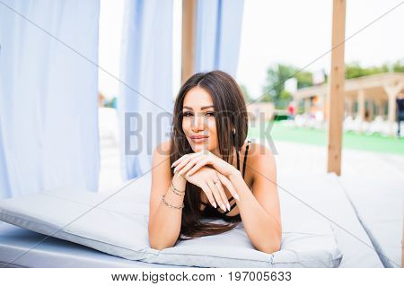 Woman Relaxing In Chaise Lounge At The Poolside. Summer Vocation