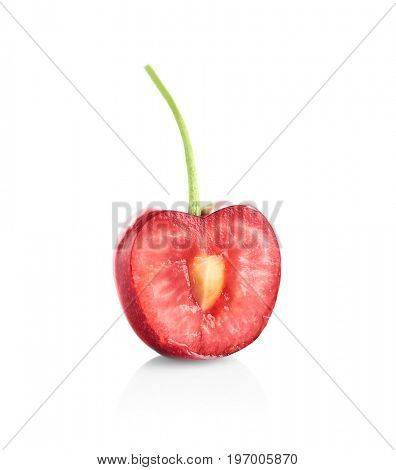 Fresh ripe cherry cut in half on white background
