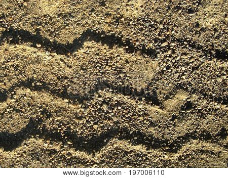 Sand. Sand background.Abstract footprints in the sand. Sand texture. Sandy background. Nature background.