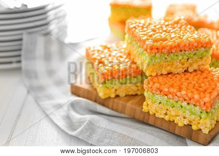 Cutting board with delicious rice treats on light table
