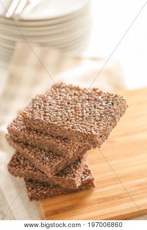 Cutting board with delicious chocolate rice treats on light table