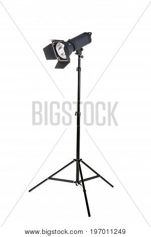 Studio flash isolated on a white background. Photo-studio with lighting equipment. Modern powerful photographic flash. Professional equipment. Studio photography video light. A long tripod.
