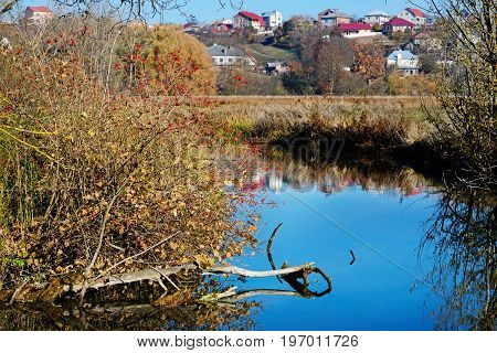 A View Of The Blue Water Flow And Vegetation In The Countryside.