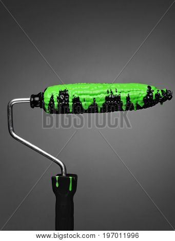 Paint Roller black corn with pouring green toxic paint on gray background. Fashion food concept.Creative advertising of paint.