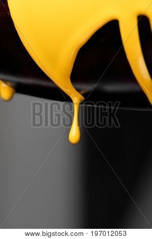 Eggplant with pouring yellow paint background, macro closeup.Texture