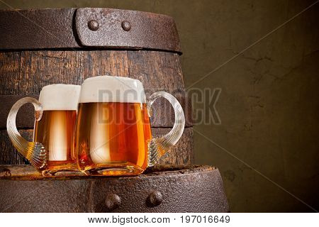 Two Glasses of Beer on the Wooden Barrel